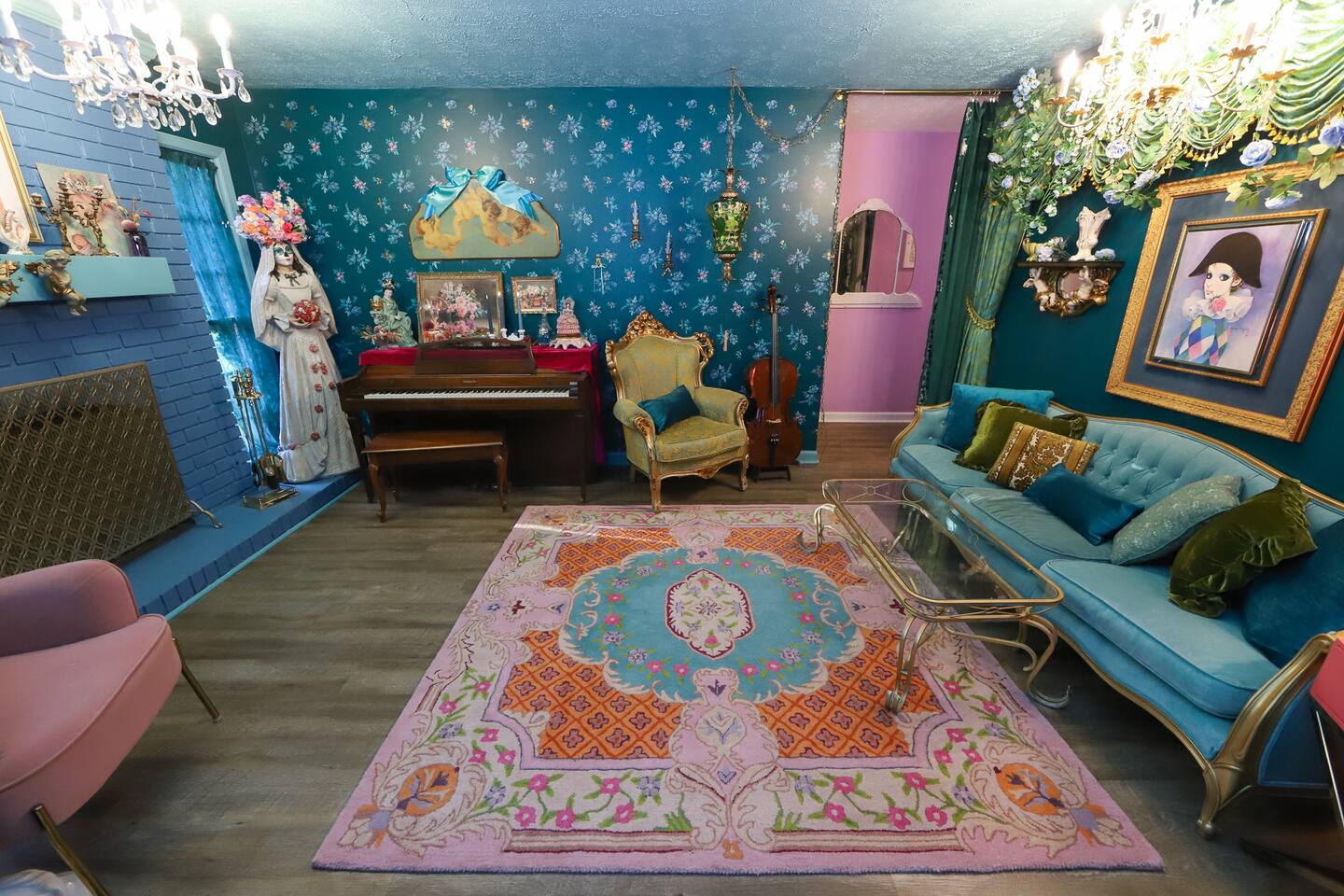 Living room with teal wallpaper and fireplace